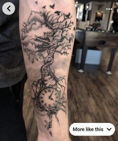 a person with a tattoo on their arm that has a clock and tree growing out of it