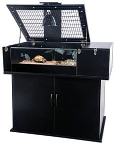 a large black cabinet with an aquarium in it