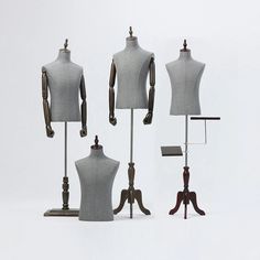 three mannequins are standing next to each other in different positions on stands