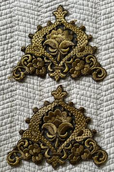 This pair of appliques are hand-embroidered on black net, using two shades of gold thread.  Dating around 1940s, they are in very good condition, with only a bit of fraying at the bottom corners. The appliques measure 6-1/2" wide (16.8cm) x 5-1/2" high (14cm). Traditional Gold Embroidered Fabric, Traditional Gold Embroidered Fabric With Machine Embroidery, Traditional Gold Embroidered Fabric With Intricate Details, Traditional Gold Fabric With Intricate Embroidery, Traditional Gold Machine Embroidered Fabric, Traditional Semi-stitched Embroidered Fabric With Gold Embroidery, Traditional Gold Sequin Fabric With Intricate Embroidery, Gold Applique, Gold Thread