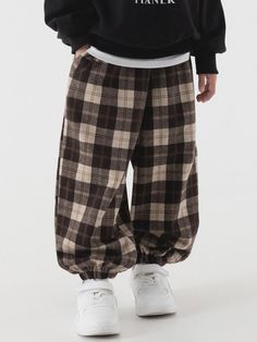 These tartan check wide jogger pants feature a comfortable elastic waistband and hem design, offering both style and mobility in a versatile brown colorway. The pants are crafted from a premium blend of polyester, rayon, and spandex, creating a soft-touch weighted fabric perfect for spring and fall wear. Available in five kids' sizes with a wide-leg silhouette, these pants come in four classic colors and include detailed size measurements to ensure the perfect fit for children between 110-160cm Dark Brows, Oversized Pants, Fall Wear, Bottom Clothes, Spring And Fall, Jogger Pants, Tartan, Dark Brown, Perfect Fit