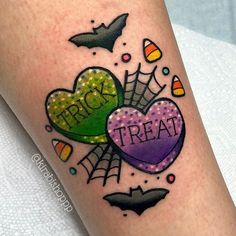 a halloween themed tattoo on the leg of a woman's leg with words trick or treat