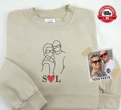 Couple Photo Portrait Sweatshirt, Embroidered Outline Sketch Jumper, Custom Initials Couple Matching Sweater, Personalised Birthday Gifts 🌟 Important Notes: The listed price includes a sketch of up to two persons. Additional charges will apply for each extra person. 👥 We will share the artwork with you before processing your order. 🖼️✨ 📸 Please send us your preferred picture for the sketch. Changing the image after the first artwork approval will incur additional fees. 📝 Note: In the event of order cancellation after artwork approval, a £10 fee will be retained (covering the artwork creation setup cost), and the remaining order value will be processed accordingly. 🌟 PRODUCT DETAILS 🔍 🔸 50% Polyester 50% Cotton 🔸 Reactive Dyed 🔸 Set in Sleeve 🔸 Lycra Ribbed Cuffs, Welt & Neck 🔸 Long Sleeve T-shirt With Machine Embroidery As Gift, Long Sleeve Cotton Sweatshirt For Anniversary, Crew Neck Tops With Machine Embroidery For Gifts, Crew Neck Cotton Top For Anniversary, Cotton Crew Neck Top For Anniversary, Couples Matching Sweaters, Matching Sweaters, Garment Labels, Couple Photo