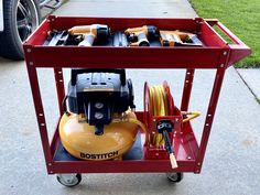 a yellow and black fire hydrant sitting on top of a red cart