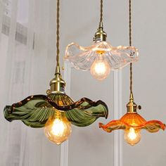 three glass lights hanging from the ceiling