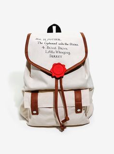 a white backpack with brown straps and a red rose on the front, sitting against a white background