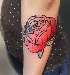 a woman's arm with a rose tattoo on the left side of her arm