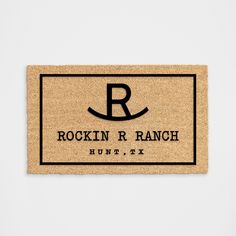 a door mat with the name rockin'r ranch on it in black and tan