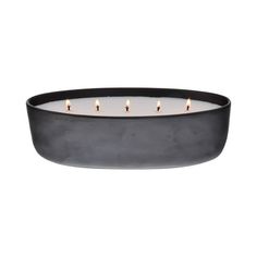 a black candle holder with five candles in the center and three lit candles on each side