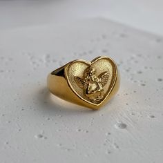 This ring is shaped like a heart, featuring the image of Cupid. It has a romantic feel and impeccable quality. Material: Stainless Steel. Finish: 18k Gold Plated. 🔸more from us🔸 https://www.etsy.com/shop/DoraJewelryAccessory Chunky Heart Ring, Chunky Gold Rings, Melted Gold, Angel Ring, Gold Clock, Tarnished Jewelry, Nice Outfits, Waterproof Jewelry, Ring Vintage