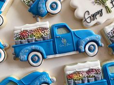 blue truck decorated cookies sitting on top of a table