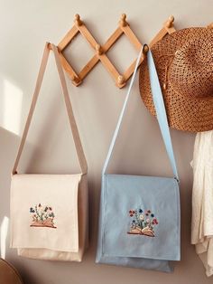 three purses are hanging on the wall with hats and other items in front of them