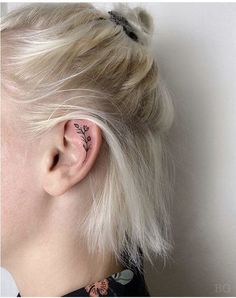 a woman with a tattoo on her left ear