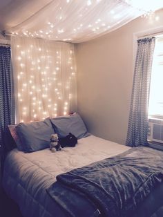 a bedroom with lights on the ceiling and a bed