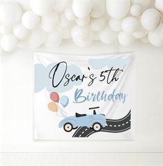 a birthday banner with a car and balloons