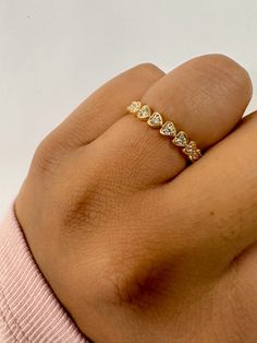 a woman's hand with a yellow gold ring on top of her left hand