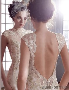 the back of a woman's wedding dress is shown in front of a window