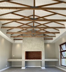 an empty room with wooden beams and shelves