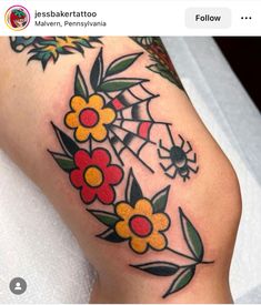 a woman's leg with flowers and spider web on it