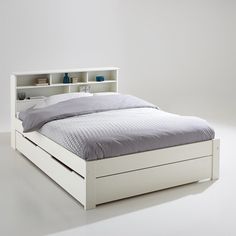 a white bed with an open bookcase headboard and foot board on the side