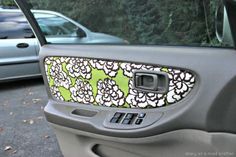 the side view mirror of a car with flowers painted on it's side window