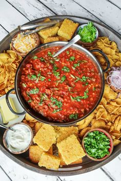 a platter filled with chips and salsa