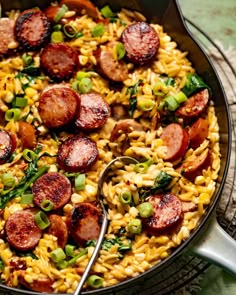 a skillet filled with pasta and sausage