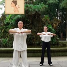 two people doing yoga in front of trees