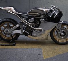 a silver and black motorcycle parked in front of a building