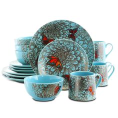 a set of blue dishes and cups with red butterflies on them, sitting next to each other