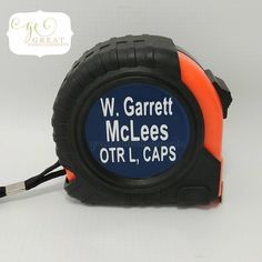 an orange and black tape measure with the words w garrett mcleaes otrl caps on it