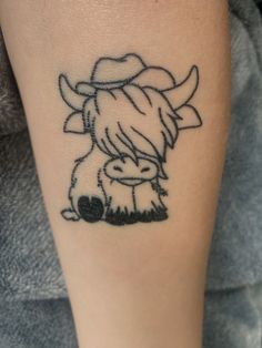 a small tattoo on the arm of a person with a cow head and horns in it