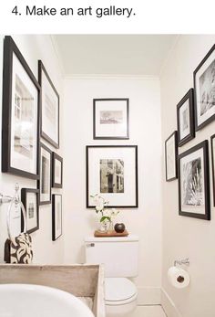 a white bathroom with black and white pictures on the wall