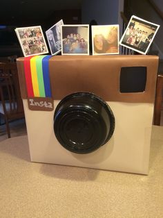 an instax camera made out of cardboard and photos