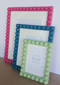 three different colored frames sitting next to each other