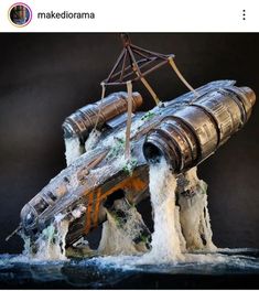 a model ship made out of metal pipes in the water with waves coming from it