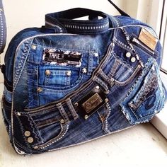 a blue jean purse sitting on top of a window sill