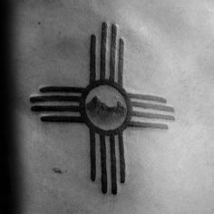 a black and white photo of a tattoo with mountains in the background