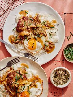 two white plates topped with eggs and rice