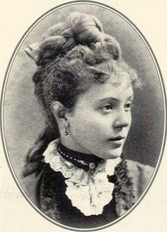 an old black and white photo of a woman with braids in her hair, looking to the side