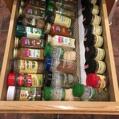 an organized spice drawer with spices and condiments in it on the tile floor