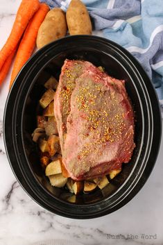 a pot roast with potatoes and carrots on the side