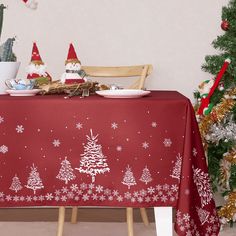 a table covered with a red christmas table cloth