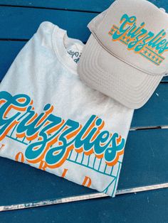 Show the love for your favorite team in this Memphis Basketball oversized tshirt that is inspired by vintage 90s NBA tshirts!- Features the words "Grizzlies World Champs" with a retro basketball design all in orange and turquoise ink- Screen print transfer that is heat pressed onto each tshirt- Tshirt is a super soft vintage wash that gets softer after each wash- Oversized fit- Sizing translation: XS/S = L , S/M = XL , L/XL = 2XL , 2XL/3XL = 3XL- Size up if you want a tshirt dress fit- 100% Cott Throwback Letter Print T-shirt For College, Retro T-shirt For Game Day In Summer, Casual Fan Merchandise T-shirt With Lettering, Orange Letter Print Tops For Game Day, Baseball Season Streetwear T-shirt With Lettering, Casual T-shirt With Lettering For Sports Events, Casual Lettering T-shirt For Sports Events, Memphis Basketball, 90s Nba