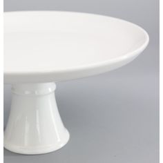 a white cake plate sitting on top of a table