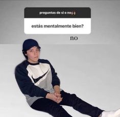 a young man sitting on top of a white floor next to a sign that says, ests mentalmente bien? no