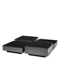 two black marble tables sitting on top of each other