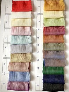 several colors of fabric laid out on top of each other with numbers in the background