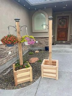 two wooden planters sitting in front of a house