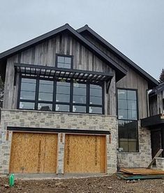 a large house with two garages on the front and one above it's doors